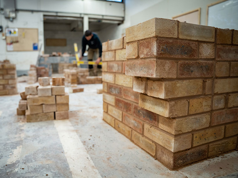 A bricklaying student in the workshop