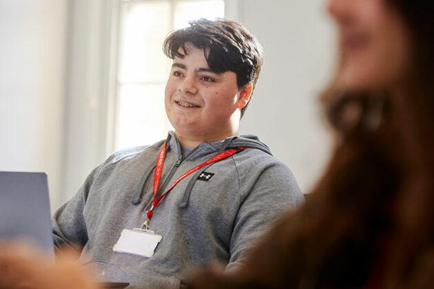 A business student sat in front of a laptop