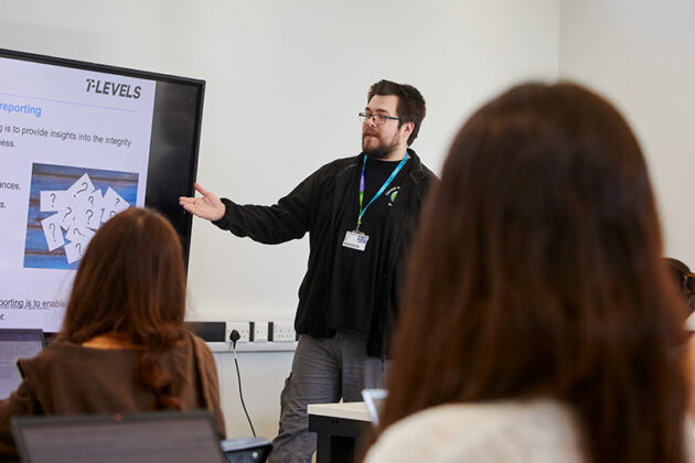 Business students in a room looking at a screen