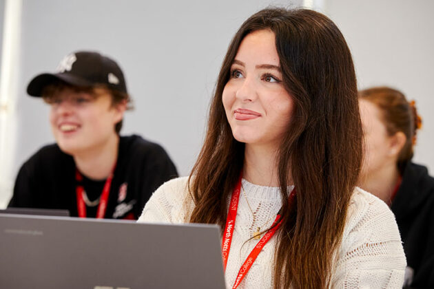 Business students sat in front of laptops