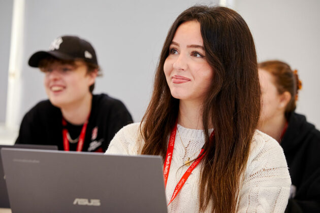 Business students sat in front of laptops