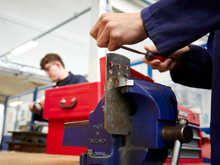A close up of an engineering student working on a project