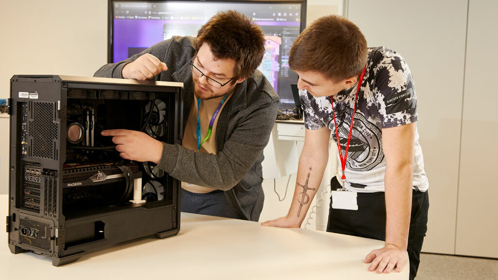 A tutor showing a student the inside of a computer