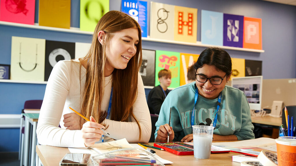 Two graphics students sat at a desk together