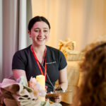 A student smiling at a client