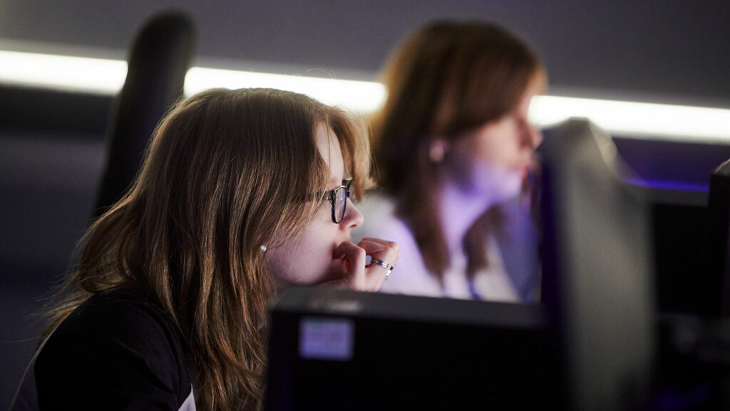 Two students looking at computer screens