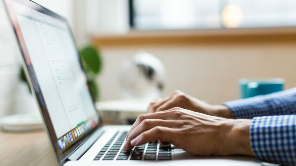 Image of someone typing on a laptop