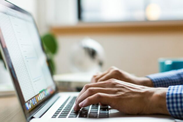 Image of someone typing on a laptop