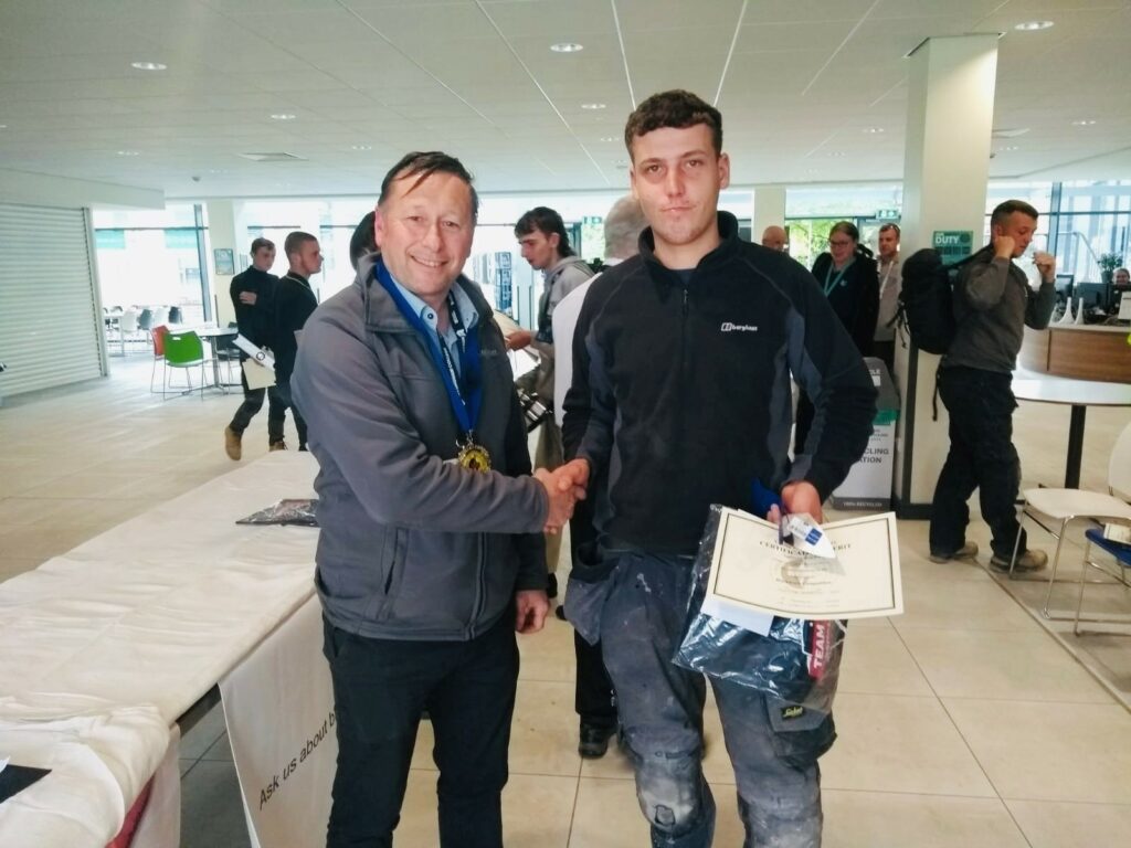 Christopher being presented with his GOB certificate