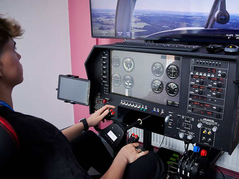An aviation student using the flight simulator