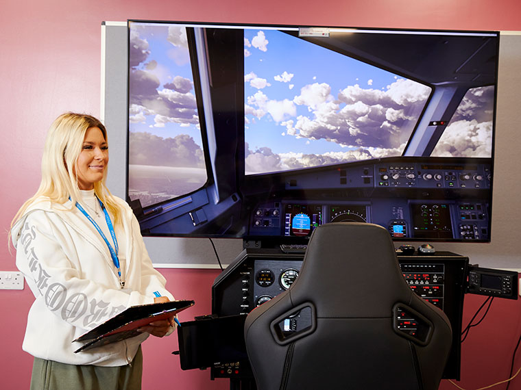 An aviation student using the flight simulator