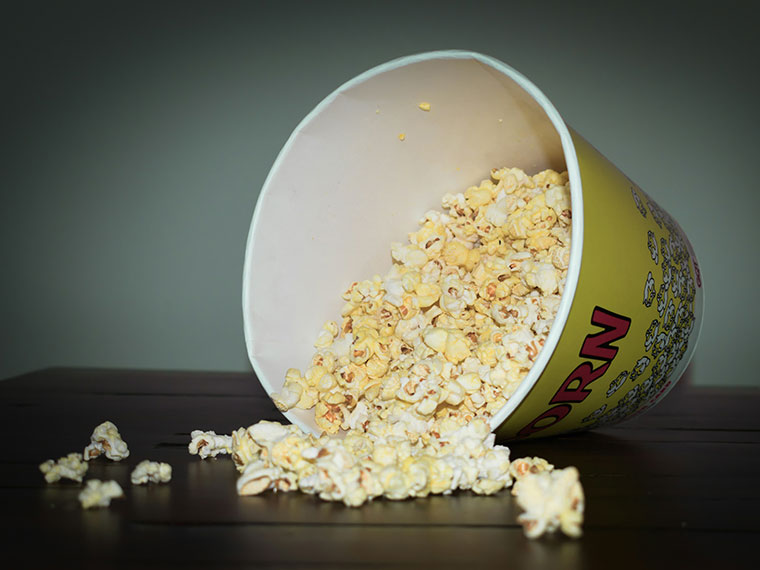 A bucket of popcorn laid on its side