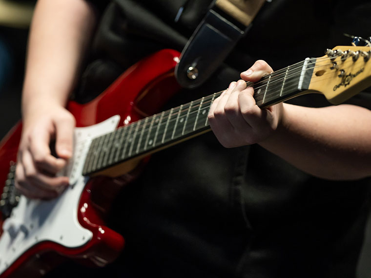 Someone playing a guitar