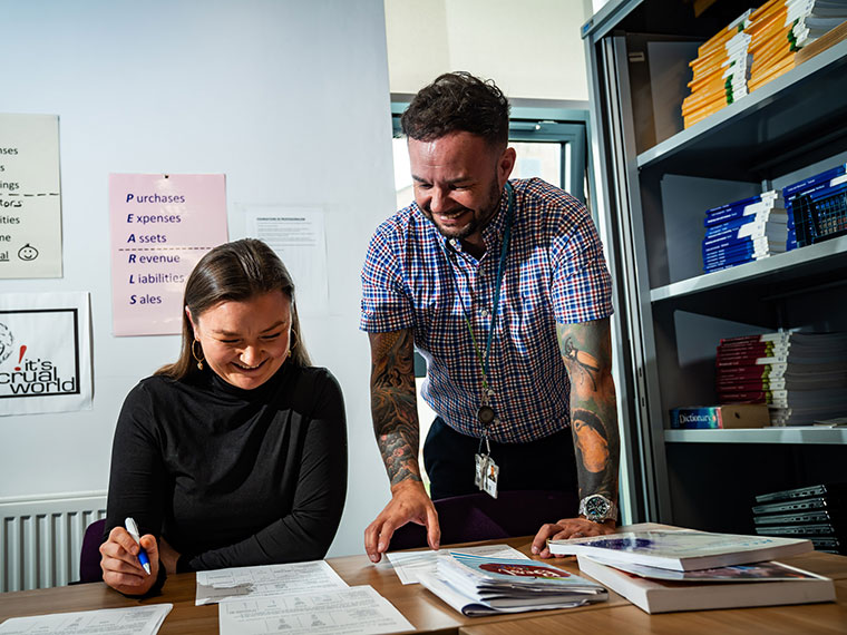 An adult learner talking to a lecturer