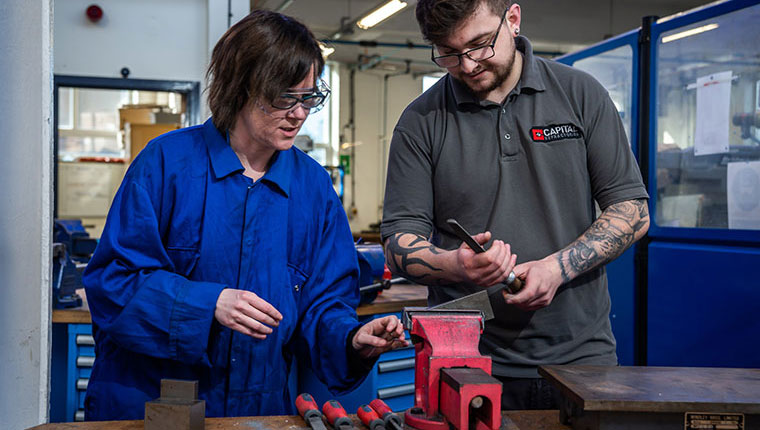 An engineering student being supported by a lecturer