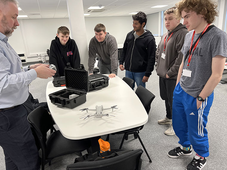 Students being shown how to use the drone