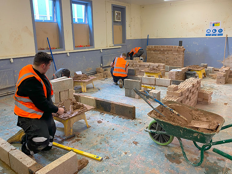 Students working on bricklaying projects in the workshop