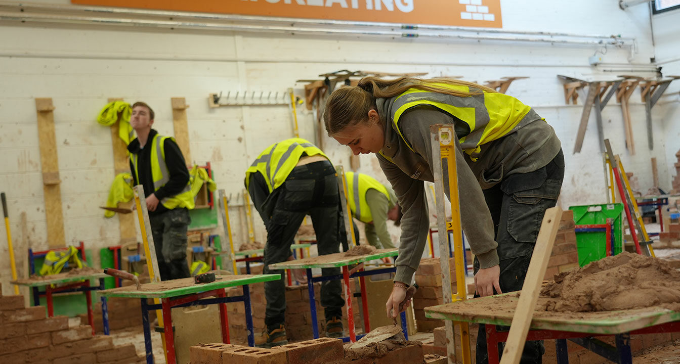 Students laying bricks in the bricklaying workshop