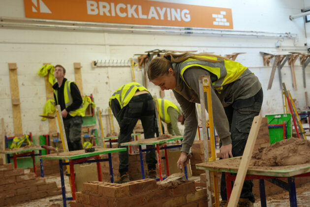 Students laying bricks in the bricklaying workshop