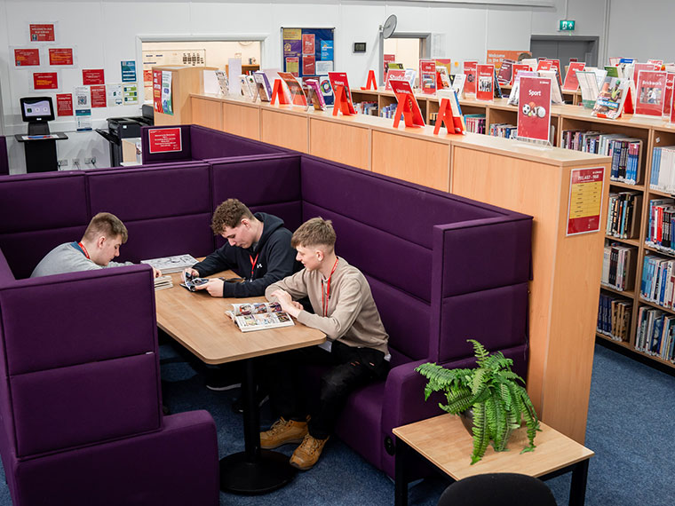 Students sat at a table in the NNC library