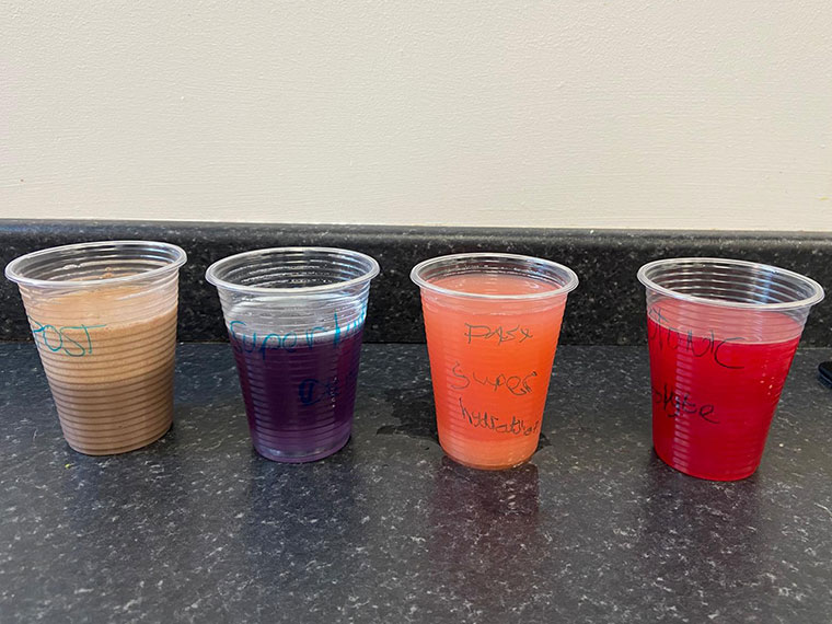Cups containing different coloured drinksfrom the experiment