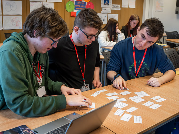 Three students sat at a table working together