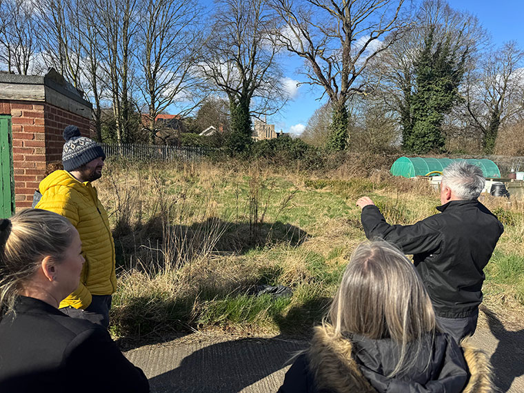 A group of people discussing a project that North Notts College construction students and Bassetlaw District Council will be working on