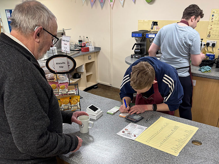 A FLEX student serving a customer in The Crossing Centre's cafe