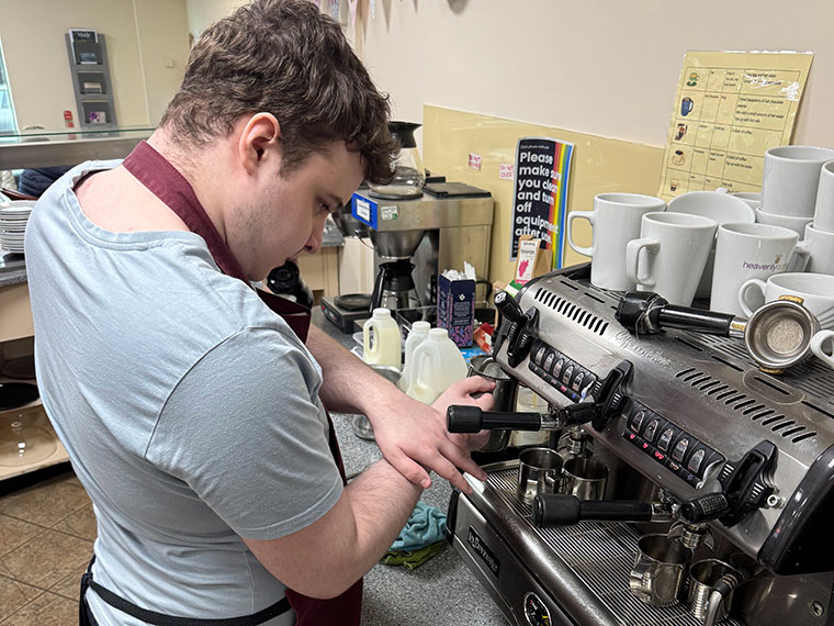 A FLEX student making hot drinks in The Crossing Centre's cafe