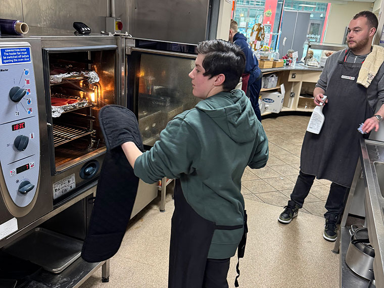 A FLEX student working in the kitchen in The Crossing Centre's cafe