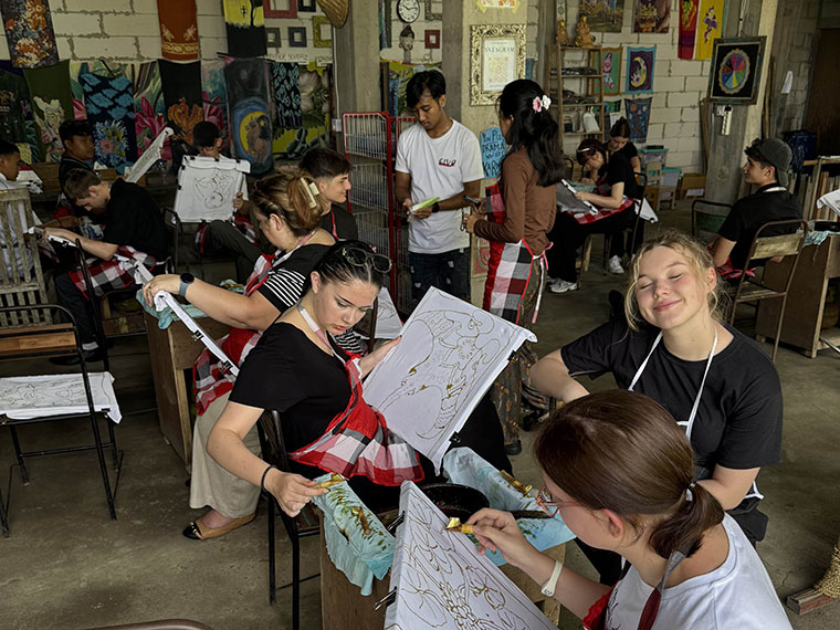 Room of people each working on a piece of art