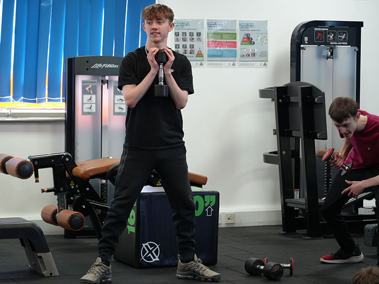 Two student lifting weights in the North Notts College gym