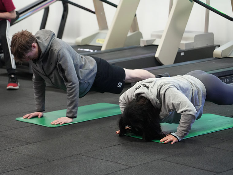 Two students doing pressups