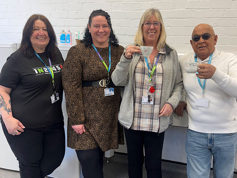 Four members of staff stood together