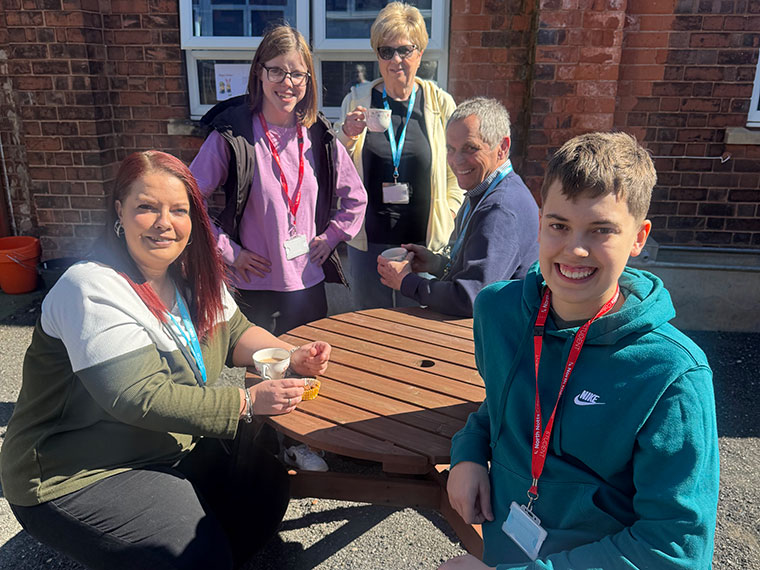 Students sat around a picnic table outside