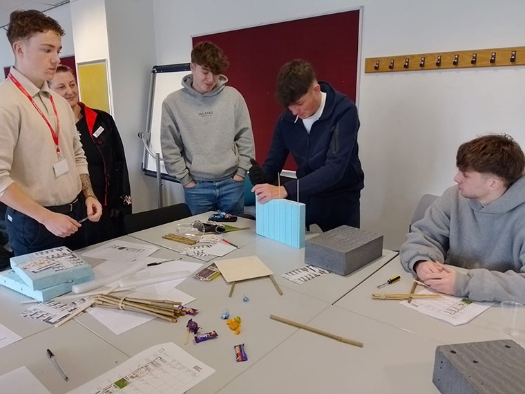 T Level students stood around a table working