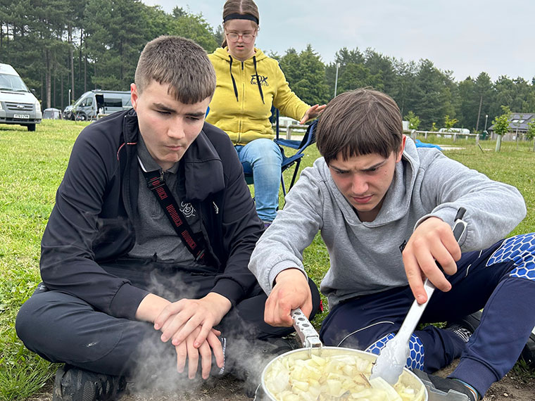 Students cooking their food outside