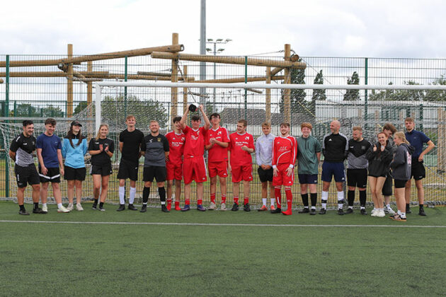 Dearne Valley College V North Notts College football teams all stood together with the trophy