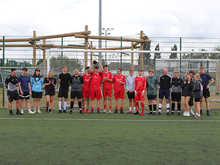 Dearne Valley College V North Notts College football teams all stood together with the trophy