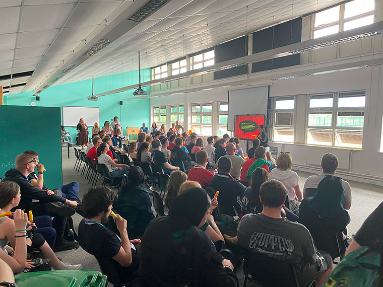 Flex students listening to a speaker during their sports day