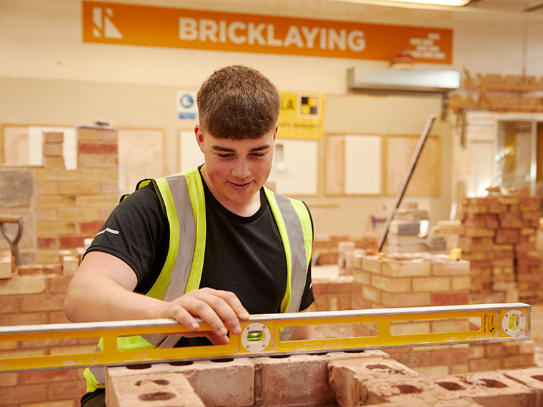 A bricklaying student in the construction workshop