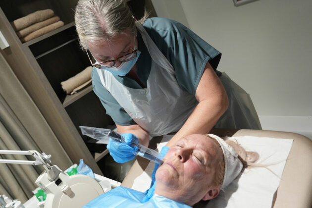 An aesthetics learner giving a client a treatment