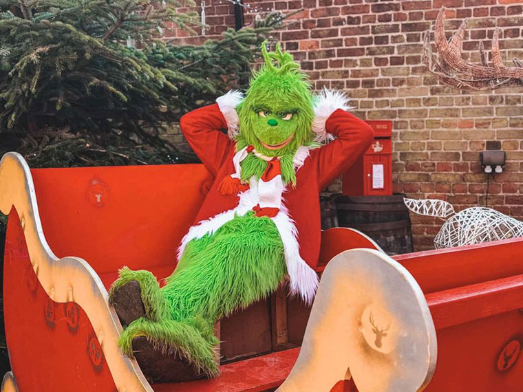 The Grinch relaxing in Santa's sleigh