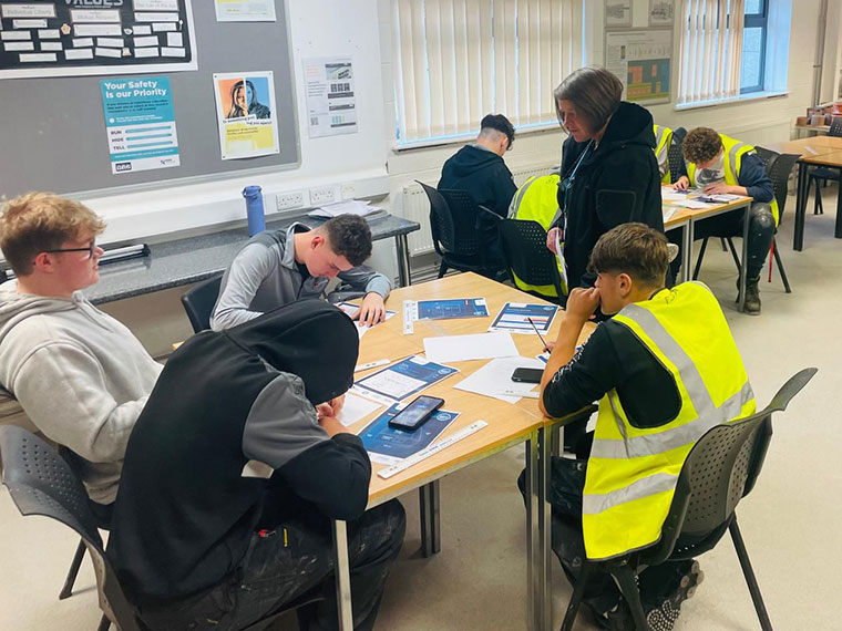 Students sat at tables in a classroom