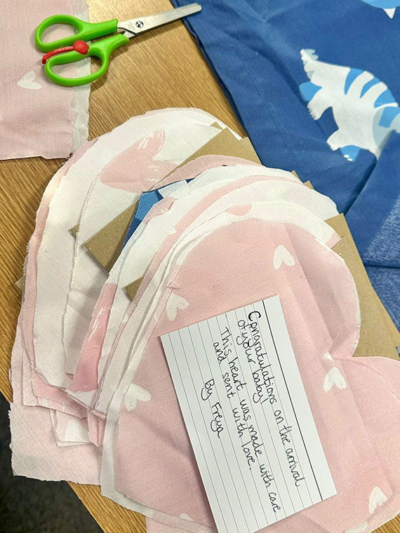 A pile of pink hearts made by RNN Group College students for Rotherham Hospital's Neonatal Unit