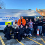 Protective Services students and two police dog handlers stood at the side of a police van