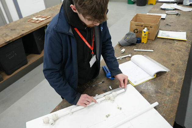 An adult learner in a plumbing class