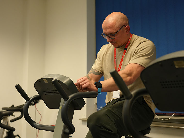 A sports learner on an exercise bike in the gym