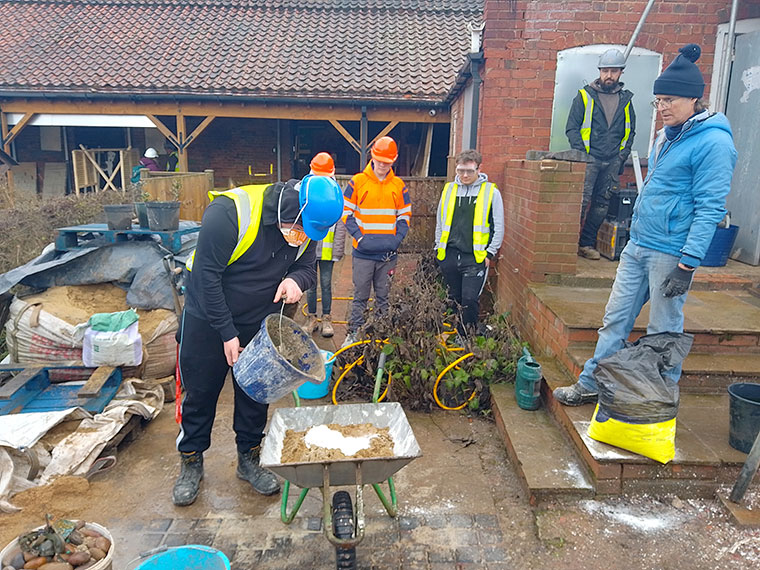 Construction students and staff working outside wearing high vis jackets