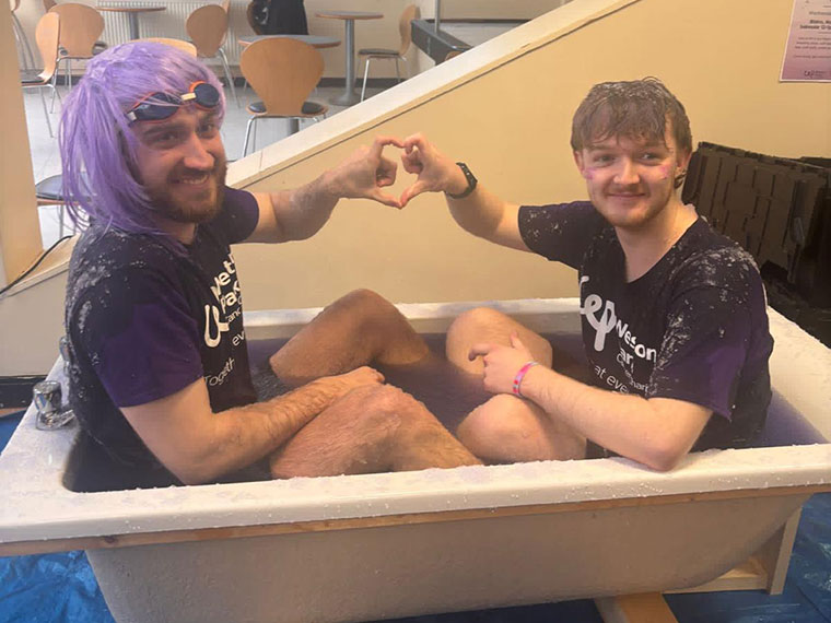 Members of staff being slimed on Wear it Purple day